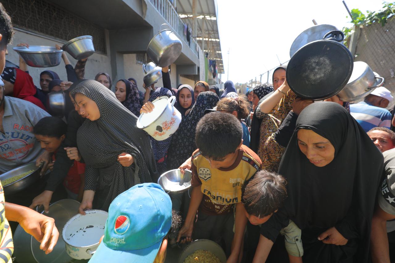 Palestinians gather to receive food distributed by organizations in Deir Al Balah, Gaza on August 31, 2025. (AA Photo)