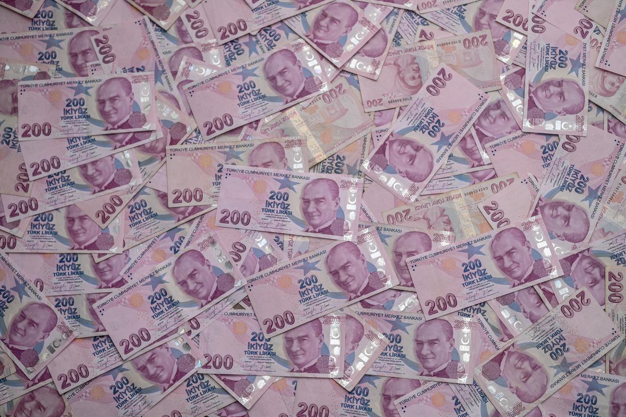 200 Turkish lira bills scattered on the table as a background in Gaziveren, Turkish Cyprus on January,  27, 2024. (Adobe Stock Photo)