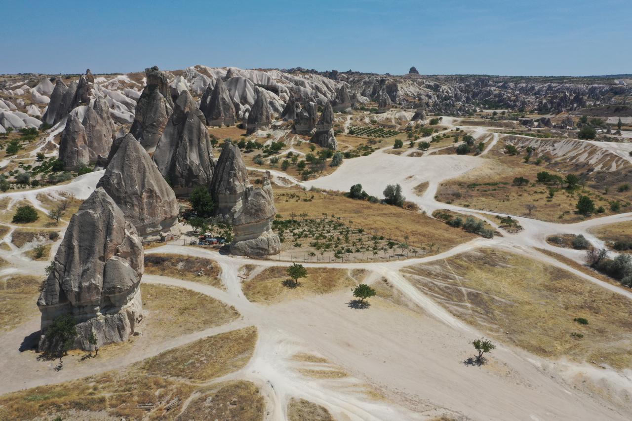 An aerial view of tourists exploring the Cappadocias famous valleys on foot or by ATV vehicles despite the extreme summer temperatures in Nevsehir, Türkiye on July 22, 2025. (AA Photo)