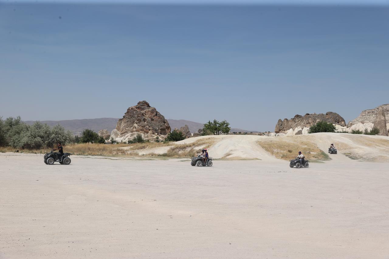 Some tourists explore the Cappadocia's famous valleys on foot or by ATV vehicles despite the extreme summer temperatures in Nevsehir, Türkiye on July 22, 2025. (AA Photo)