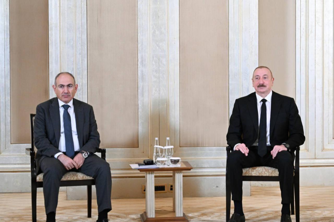 Azerbaijani President Ilham Aliyev (R) and Armenian Prime Minister Nikol Pashinyan (L) meet in Abu Dhabi, the capital of the United Arab Emirates on July 10, 2025. (Azerbaijani Presidency/AA Photo)
