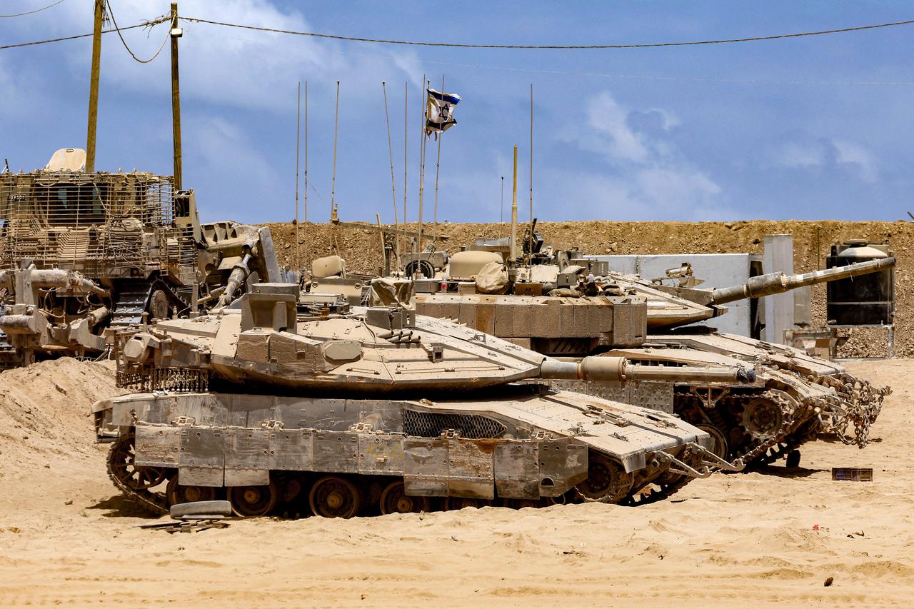 Israeli army main battle tanks are positioned near the border with the Gaza Strip in southern Israel on August 5, 2025. (AFP Photo)