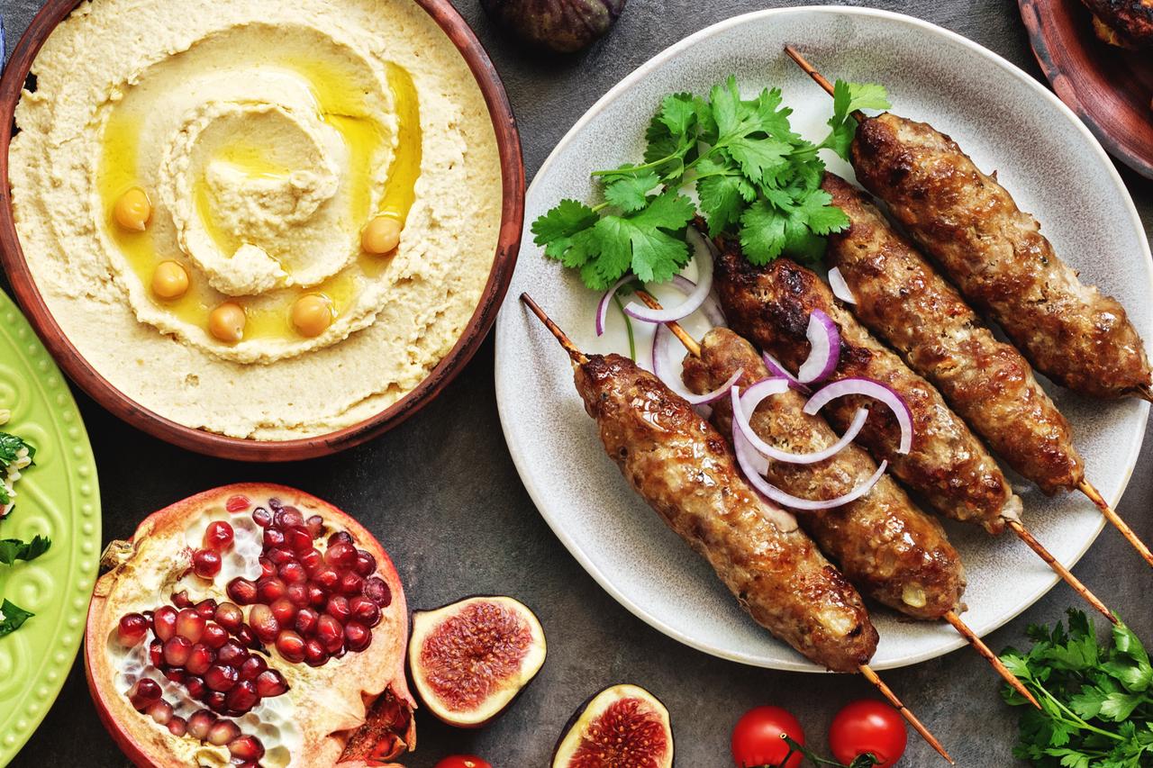 Assorted Turkish and Arabic dishes with hummus, tabbouleh, fattoush, kebab, falafel, and pomegranate. (Photo by Adobe Stock)