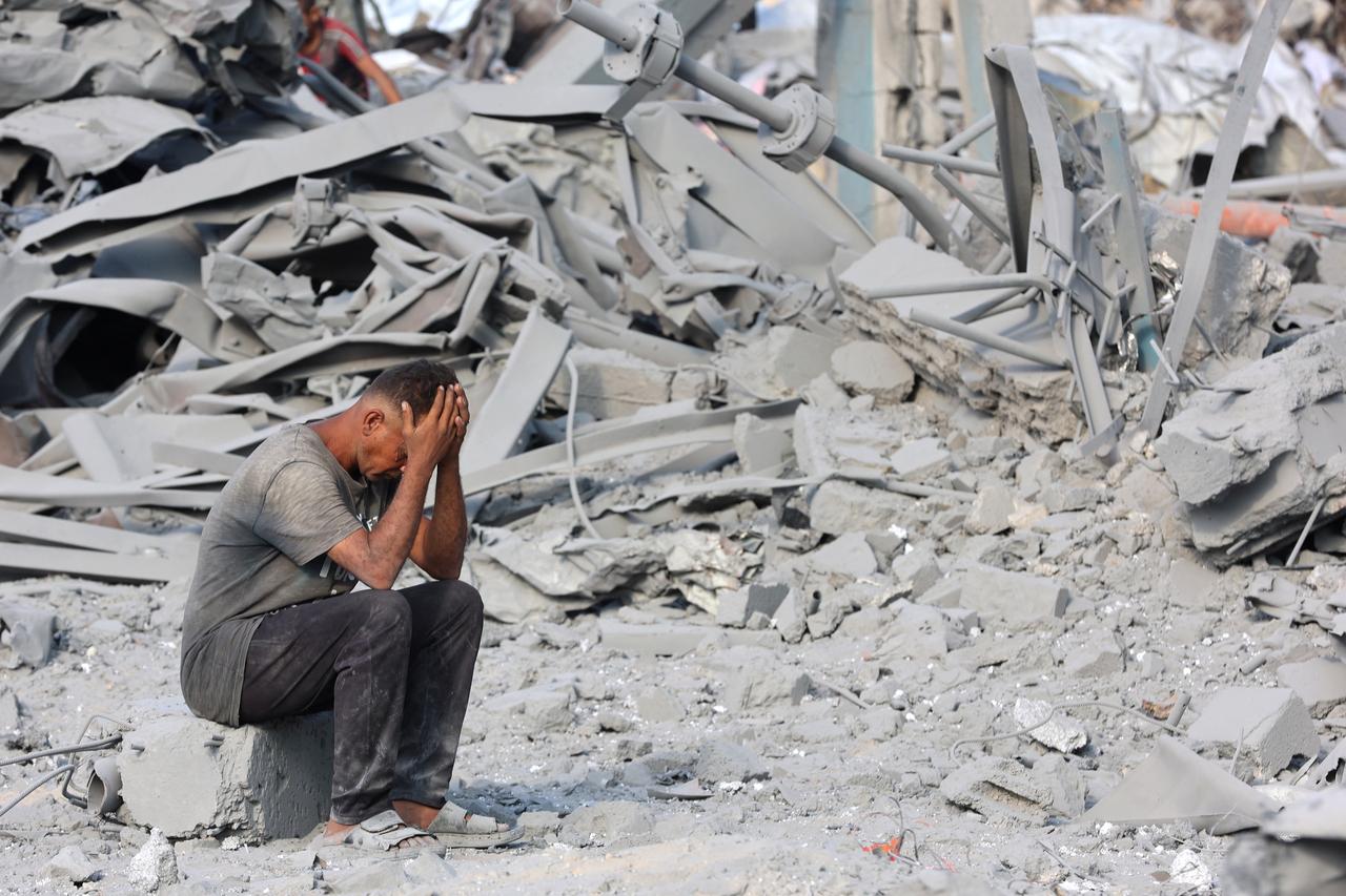 A Palestinian man reacts to the destruction after an overnight strike on the Sheikh Radwan Health Centre run by the UNRWA in the north of Gaza City on August 6, 2025. (AFP Photo)