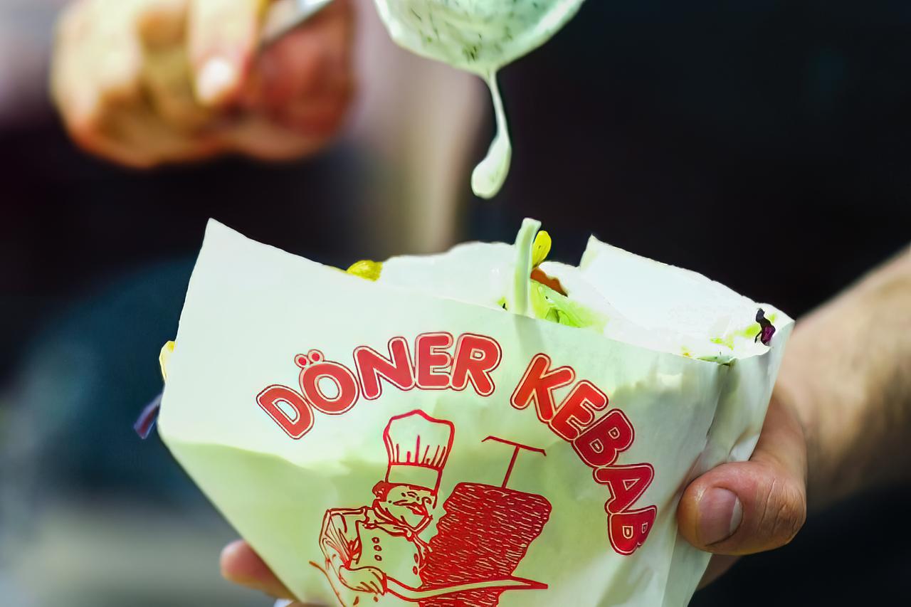 A vendor prepares a doner kebab at a Turkish food stall in Germany, March 27, 2018. (Adobe Stock Photo)