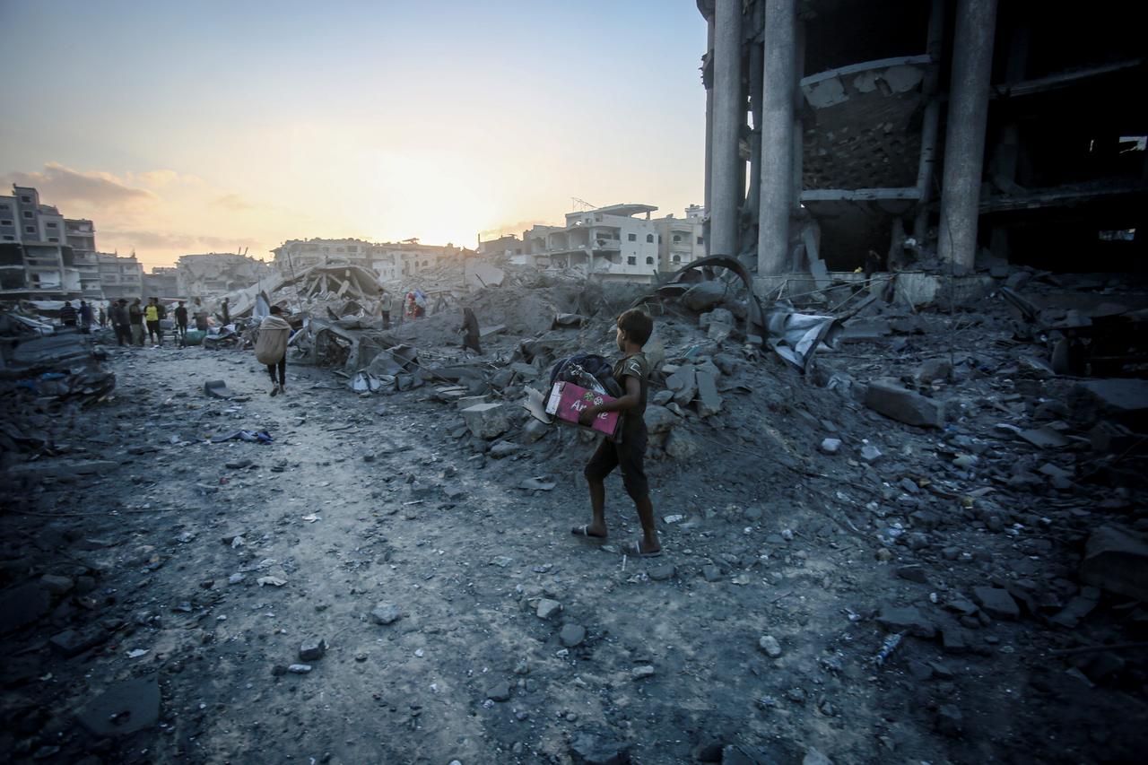 Palestinians, living at a schooll, gather to inspect the site after Israeli forces hit a health facility belonging to the United Nations Relief and Works Agency for Palestine Refugees in the Near East (UNRWA), located in the Sheikh Ridwan neighborhood in Gaza City, Gaza on August 06, 2025. (AA Photo)