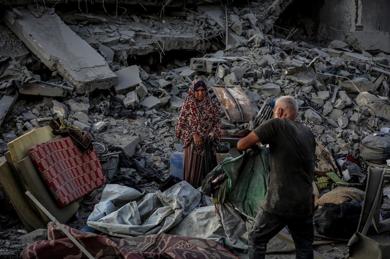 Palestinians, living at a schooll, gather to inspect the site after Israeli forces hit a health facility belonging to the United Nations Relief and Works Agency for Palestine Refugees in the Near East (UNRWA), located in the Sheikh Ridwan neighborhood in Gaza City, Gaza on August 06, 2025. (AA Photo)