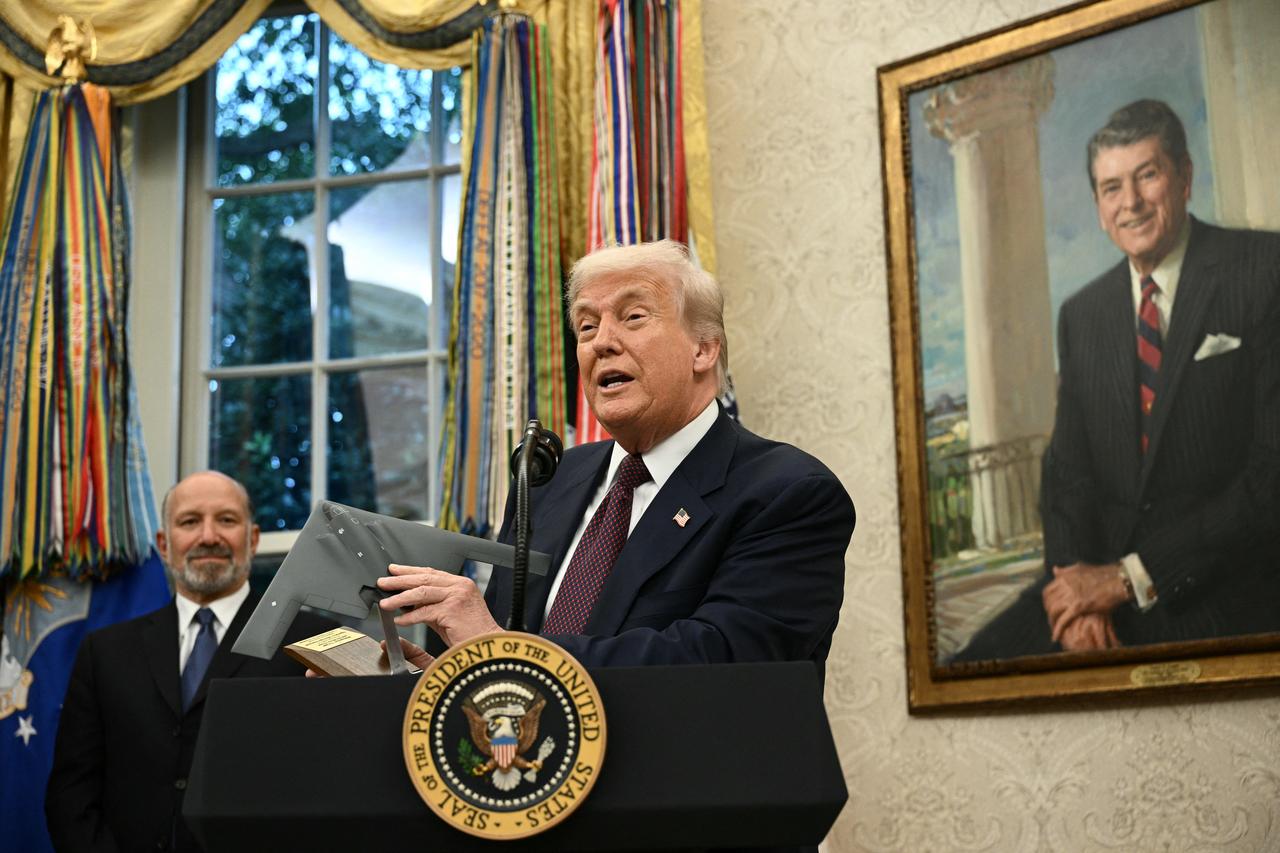 US President Donald Trump holds a model of a new version the B-2 stealth bomber as he speaks in the Oval Office of the White House in Washington, DC, on August 6, 2025. (AFP Photo)