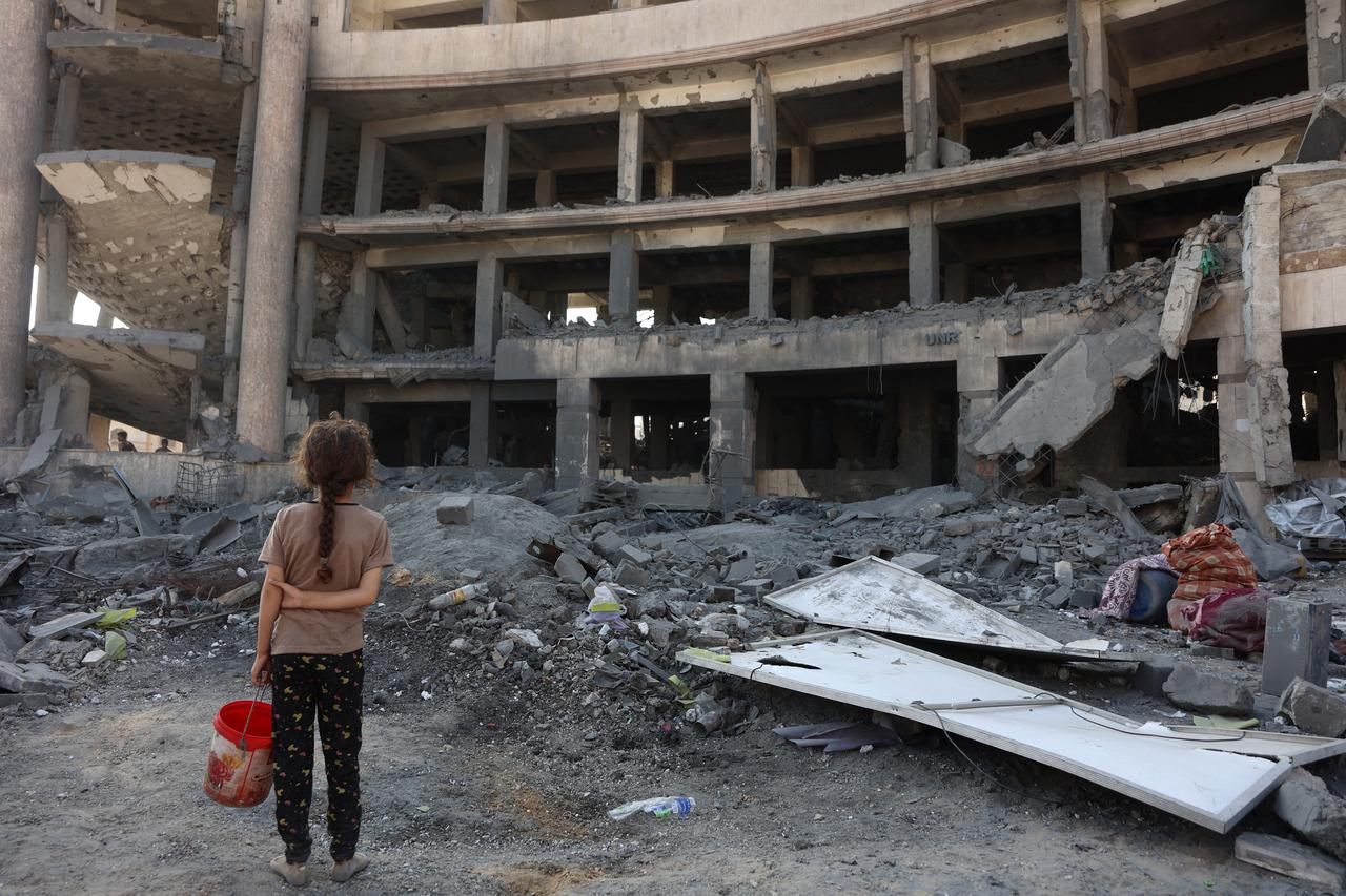 A Palestinian girl reacts to the destruction after an overnight strike on the Sheikh Radwan Health Centre run by UNRWA in north of Gaza City on August 6, 2025. (AFP Photo)