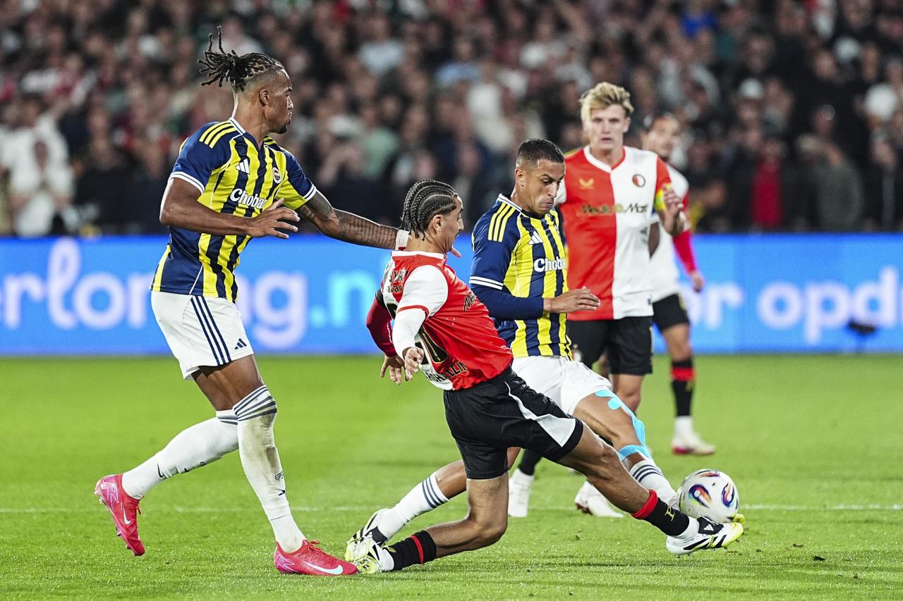 Oussama Targhalline of Feyenoord in action against Bartug Elmaz of Fenerbahce during the UEFA Champions League third qualifying round first leg match between Fenerbahce and Feyenoord, in Rotterdam, the Netherlands on August 06, 2025. (AA Photo)