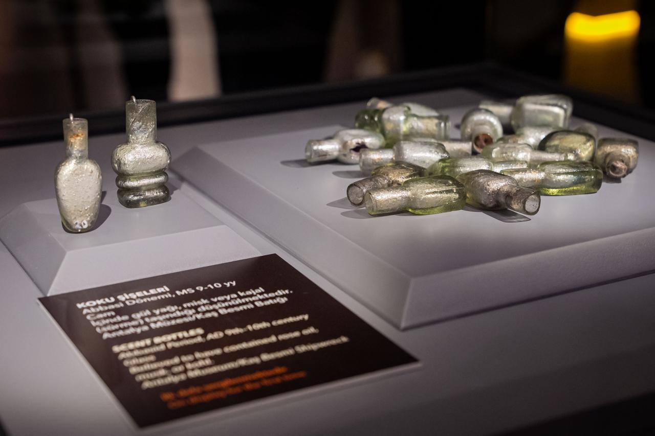 Glass perfume bottles dating back 1,000 to 1,100 years, uncovered in the wreck of a trade ship of Eastern Mediterranean origin during underwater archaeological excavations off the coast of Kas, are on display at the Golden Age of Archaeology Exhibition in the Presidential Library, Ankara, Türkiye, August 8, 2025. (AA Photo)