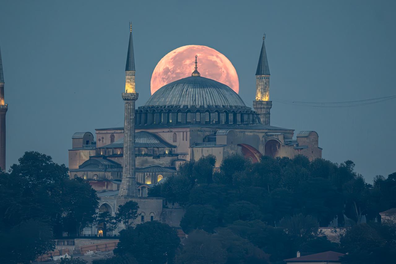 Super blue full moon rises behind the dome of Hagia Sophia, creating a striking night sky view, Istanbul, Türkiye, accessed August 8, 2025. (Aobe Stock Photo)