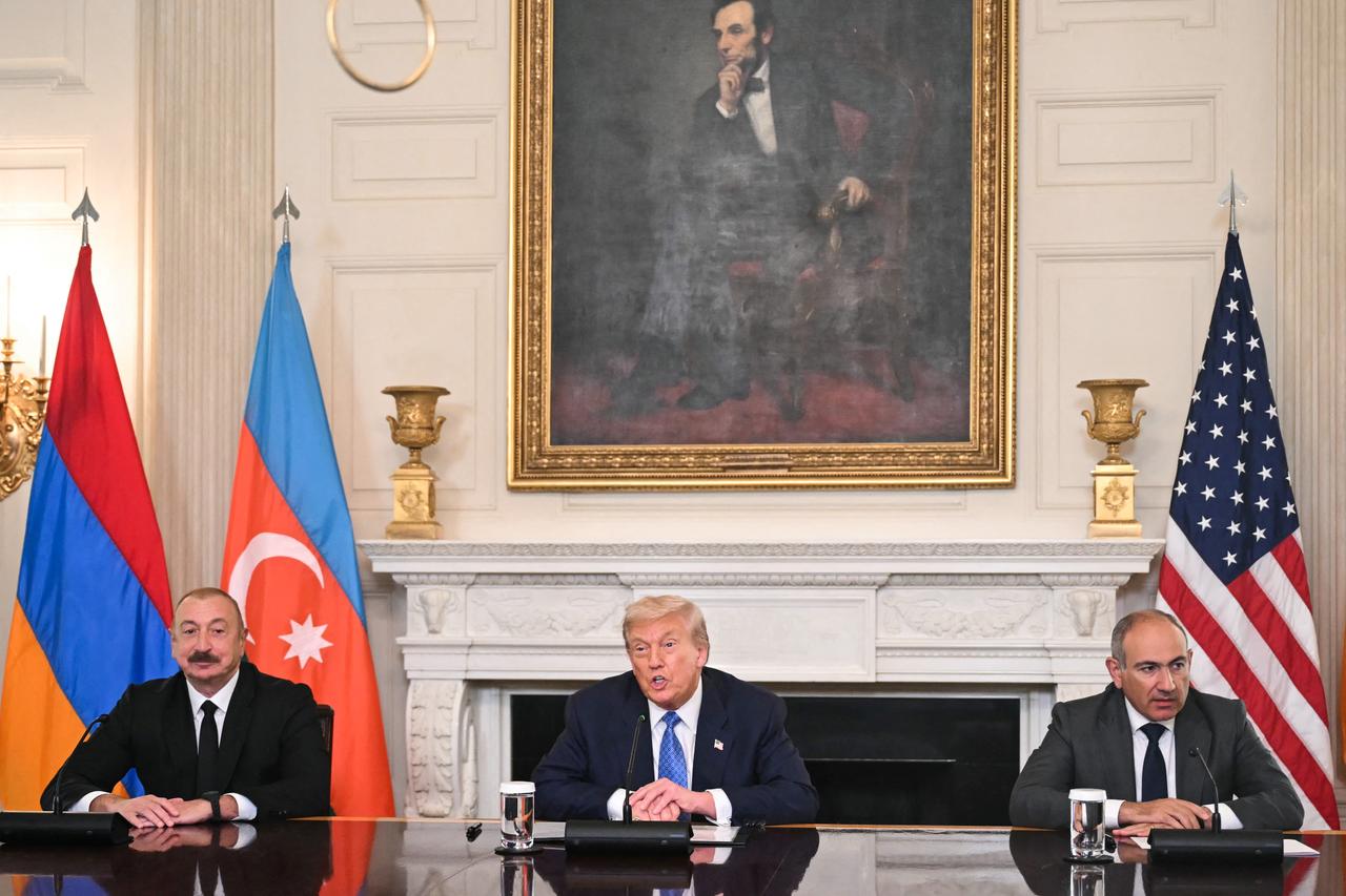 U.S. President Donald Trump participates in a trilateral signing with Azerbaijani President Ilham Aliyev (L) and Armenian Prime Minister Nikol Pashinyan (R) in the State Dining Room of the White House in Washington, U.S. on August 8, 2025. (AFP Photo)