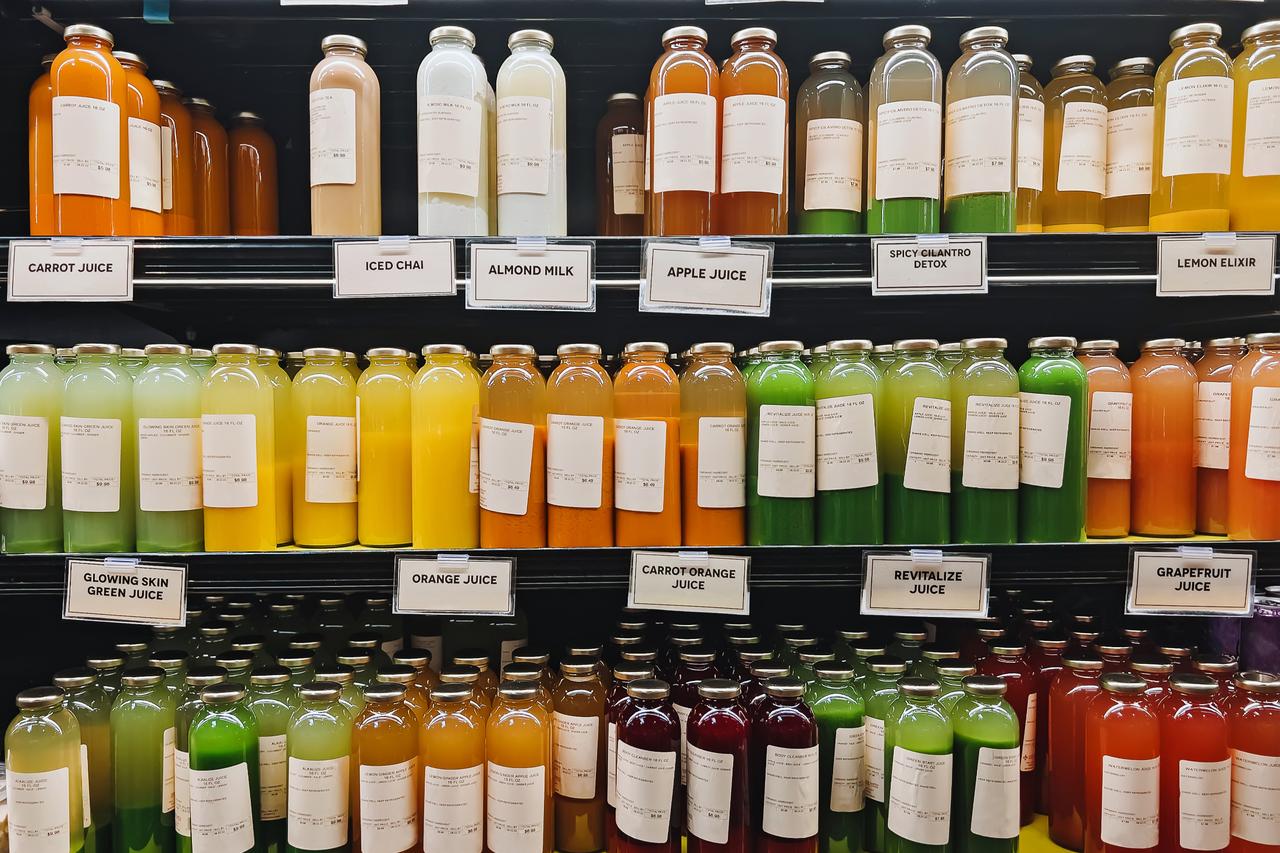File photo shows bottled organic juices and plant-based beverages displayed on shelves at a grocery store. (Adobe Stock Photo)