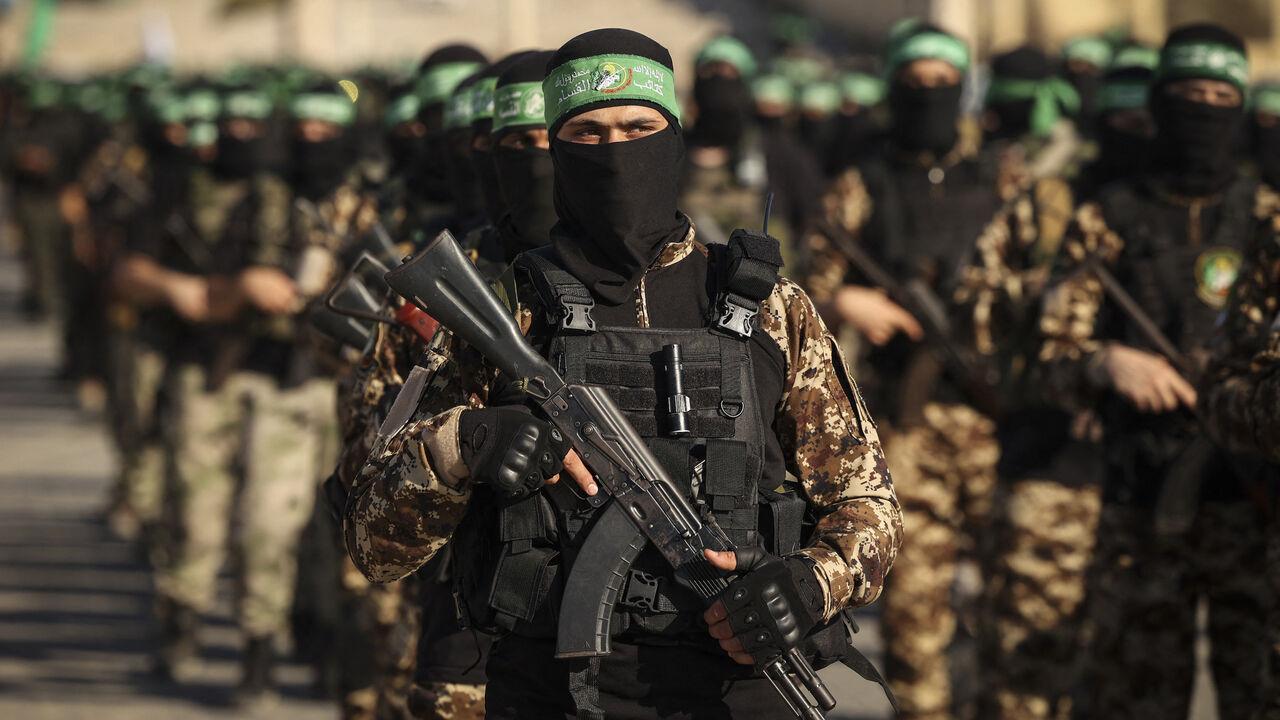 Masked members of the al-Qassam Brigades, the military wing of Hamas, march during a rally in Gaza City on July 20, 2022. (AFP Photo)