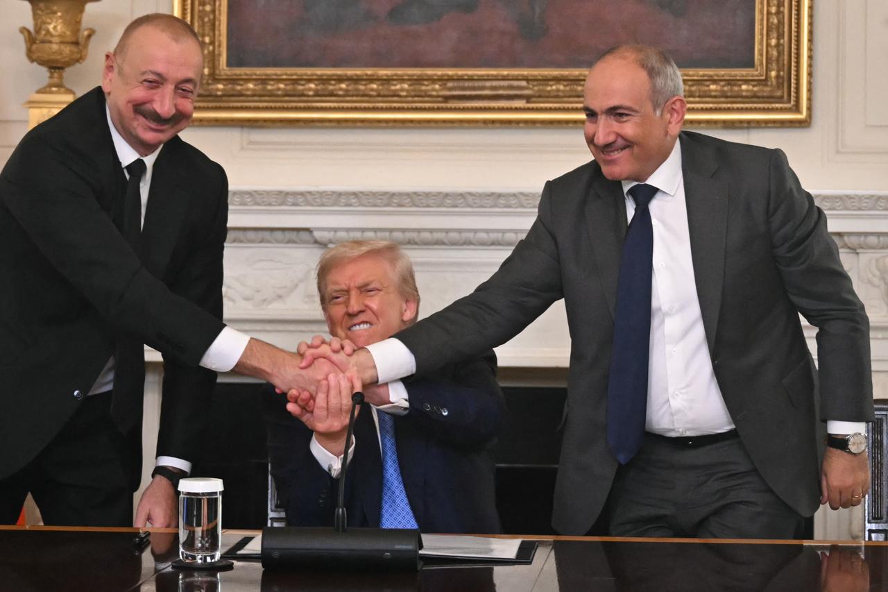 U.S. President Donald Trump (C), Azerbaijani President Ilham Aliyev (L) and Armenian Prime Minister Nikol Pashinyan shake hands after signing an agreement in the State Dining Room of the White House in Washington, U.S. on August 8, 2025. (AFP Photo)
