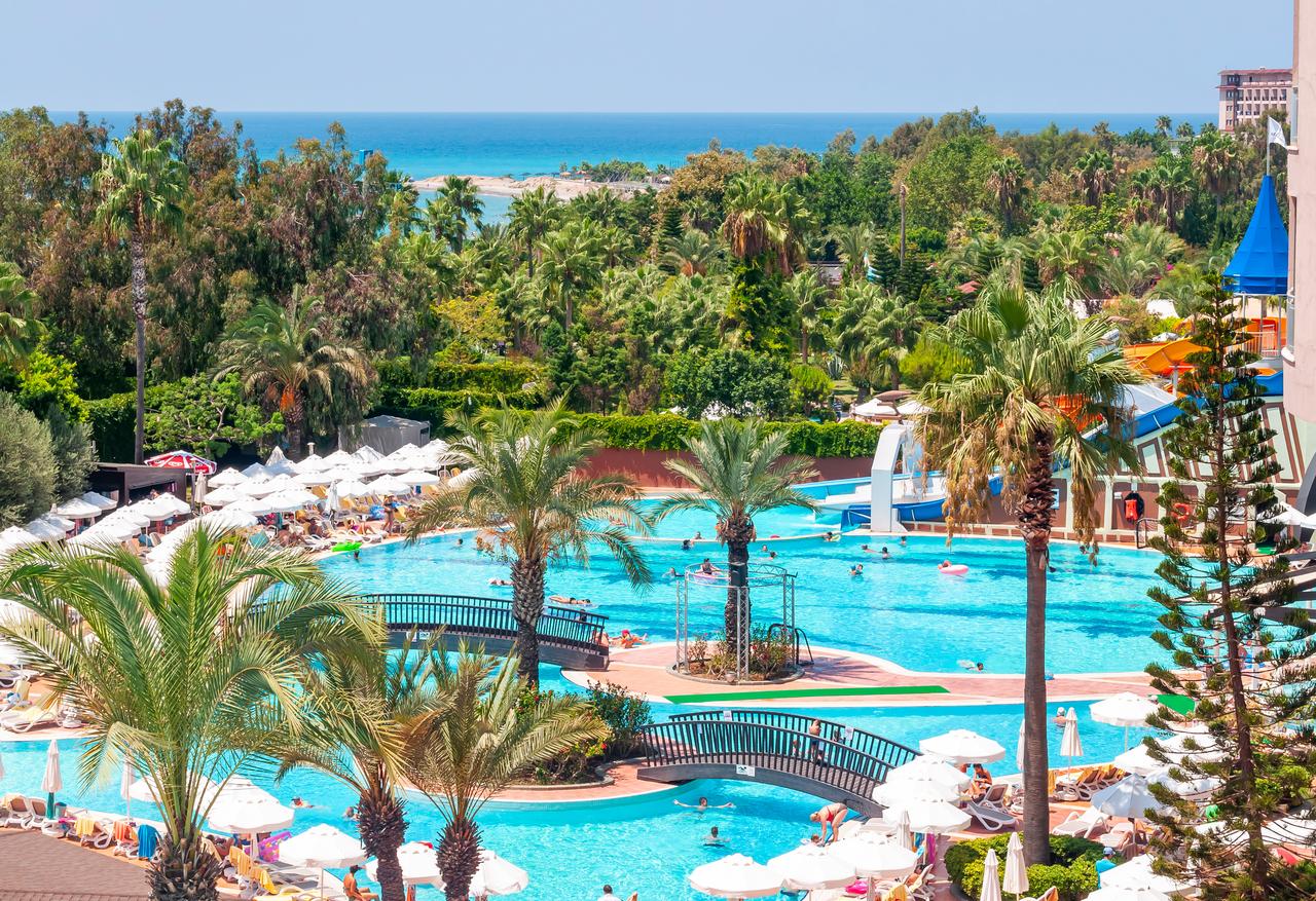 Gardens and swimming pools of hotels in Antalya, Türkiye, July 2019. (Adobe Stock Photo)