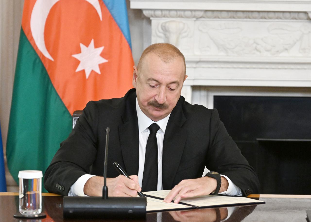 U.S. President Donald Trump (not seen), Azerbaijani President Ilham Aliyev, and Armenian Prime Minister Nikol Pashinyan (not seen) sign the joint declaration "peace roadmap" following their trilateral meeting at the White House in Washington D.C., United States on August 08, 2025. (AA Photo)