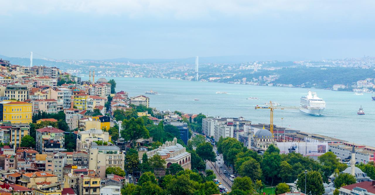 Aerial view of the Bosphorus Strait with residential neighborhoods in the foreground in Istanbul, Türkiye. (Adobe Stock)