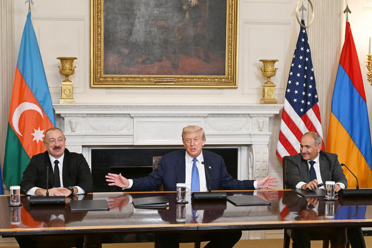 U.S. President Donald Trump (C), Azerbaijani President Ilham Aliyev (L), and Armenian Prime Minister Nikol Pashinyan (R) sign the joint declaration  peace roadmap  following their trilateral meeting at the White House in Washington D.C., United States on August 08, 2025. (Azerbaijan Presidency - AA Photo)