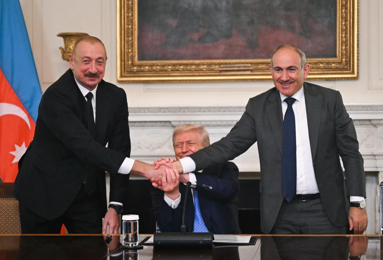 Azerbaijani President Ilham Aliyev (L), Armenian Prime Minister Nikol Pashinyan (R) and US President Donald Trump shake hands during a trilateral signing ceremony in the State Dining Room of the White House in Washington, U.S. on August 8, 2025. (AFP Photo)
