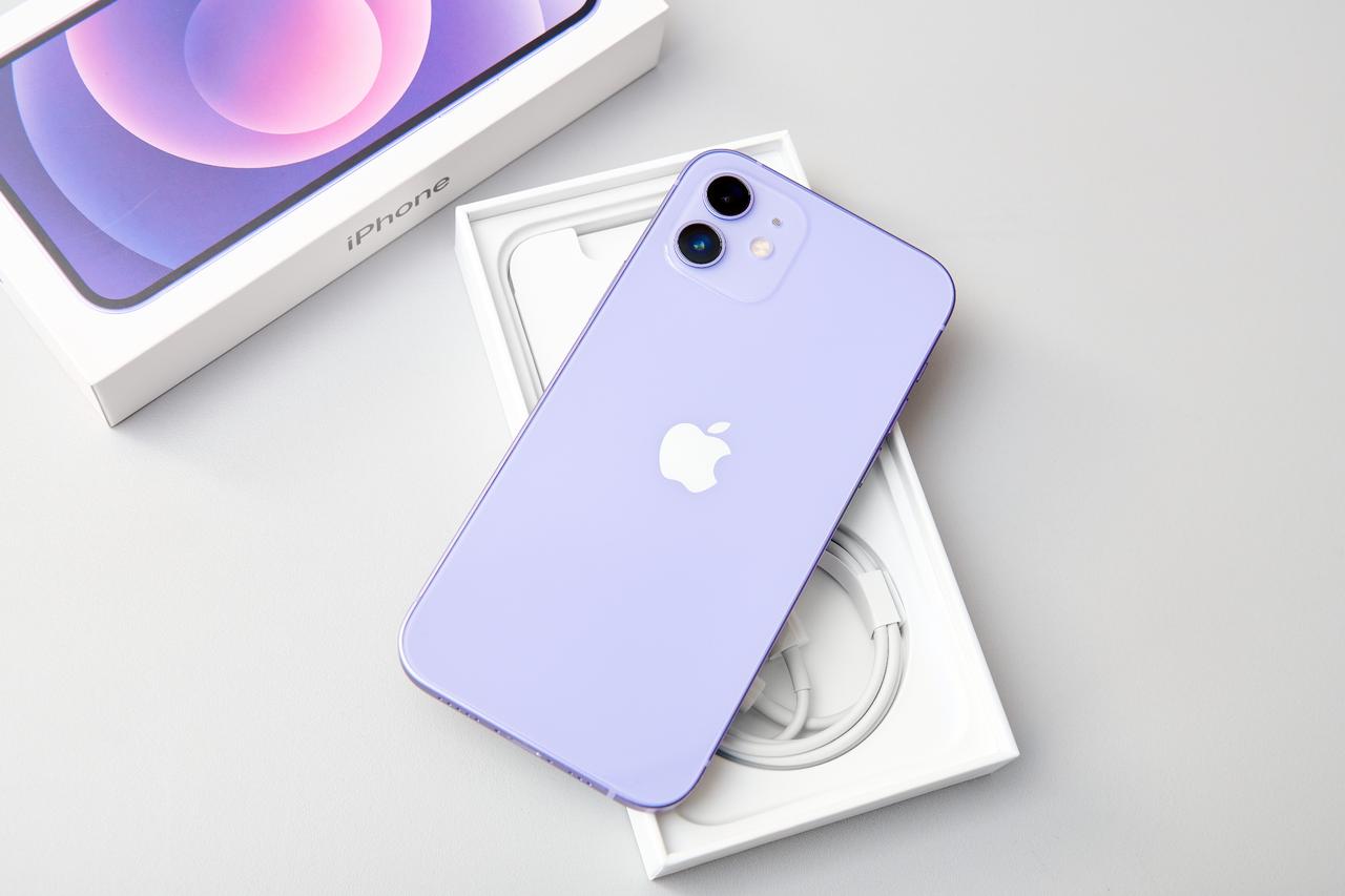 Unpacked purple Iphone 12 smartphone on the box in Moscow, Russia on Sept. 10, 2022. (Adobe Stock Photo)