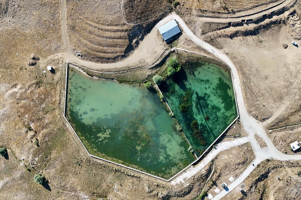 An aerial view shows the Roman pool and its water reservoir, still serving the daily needs of Sadak village, Gumushane, Türkiye, Aug. 28, 2025. (IHA Photo)