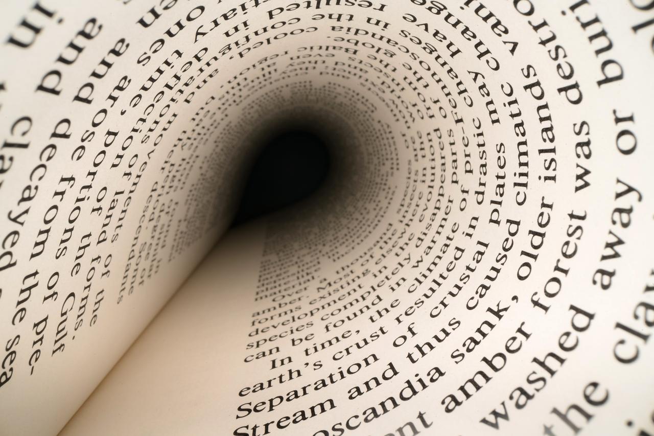 A book page curving into a tunnel, with words fading into the depth under dramatic dark light. (Adobe Stock Photo)