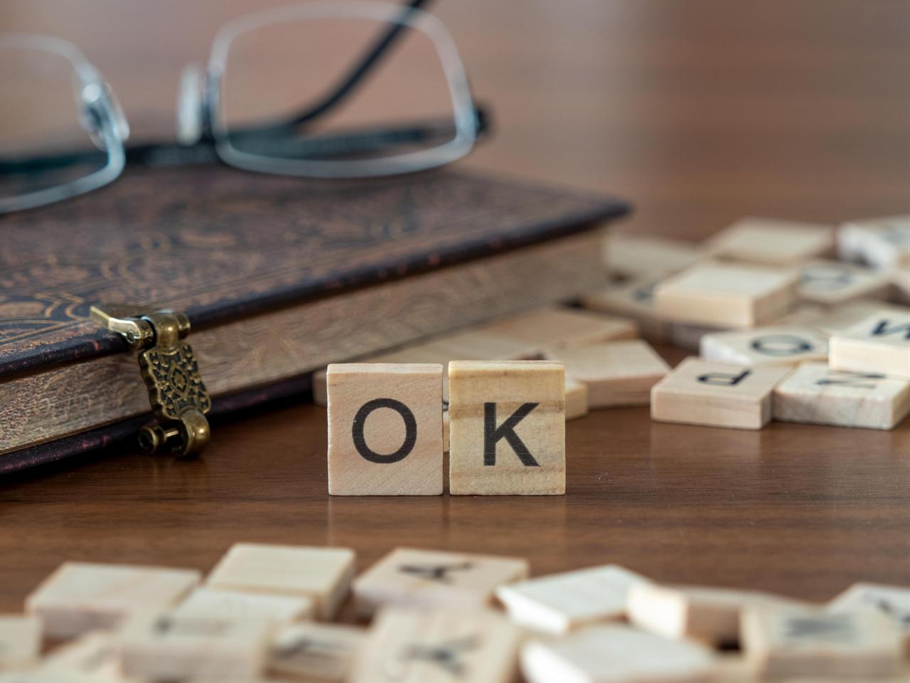 OK word or concept represented by wooden tiles on a wooden table. (Adobe Stock Photo)