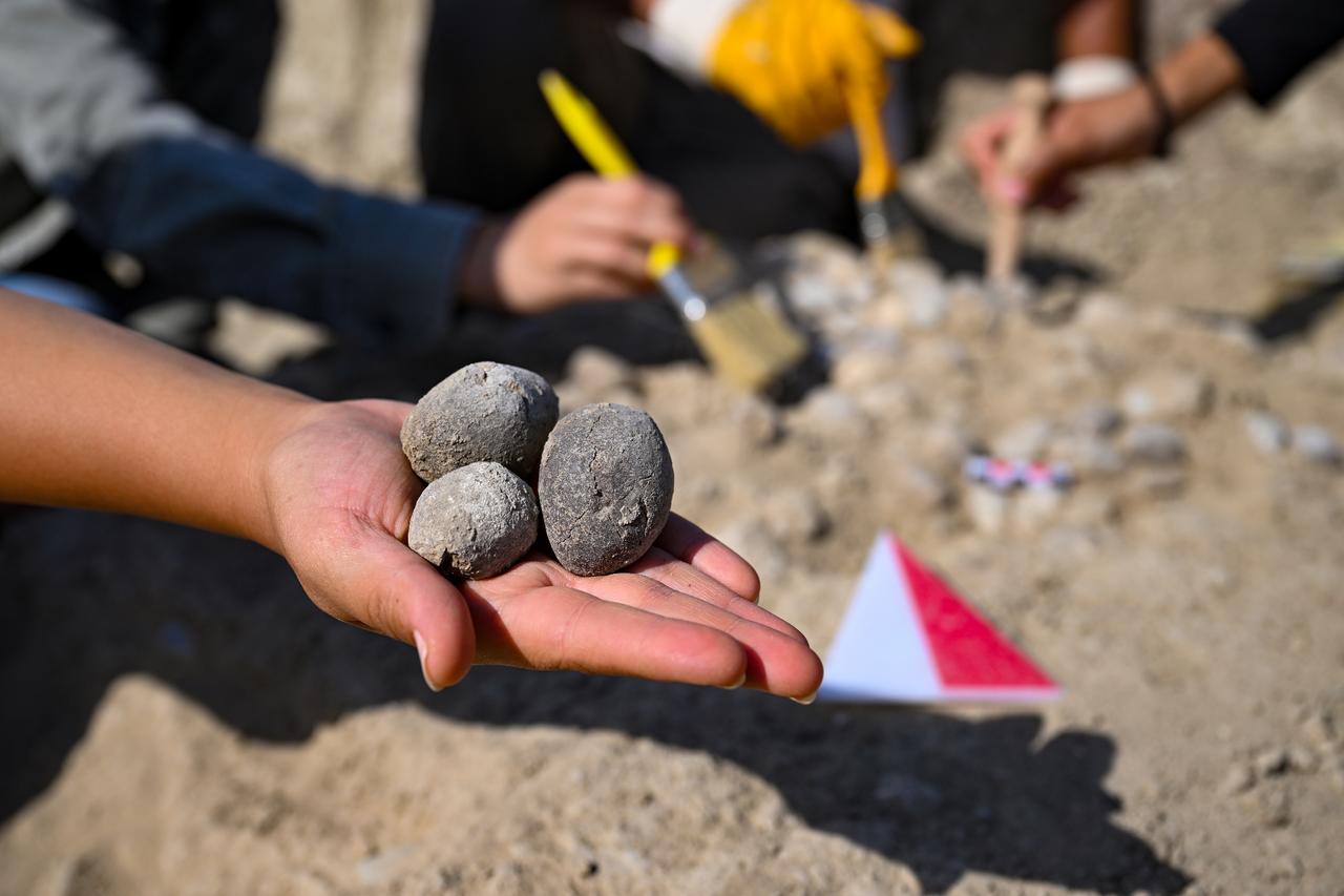 Archaeologists work to unearth sling stones used in ancient wars during ongoing excavations at Cavustepe Castle, built by Urartian King Sarduri II, in Gurpinar district of Van, Türkiye, Aug. 28, 2025. (AA Photo)