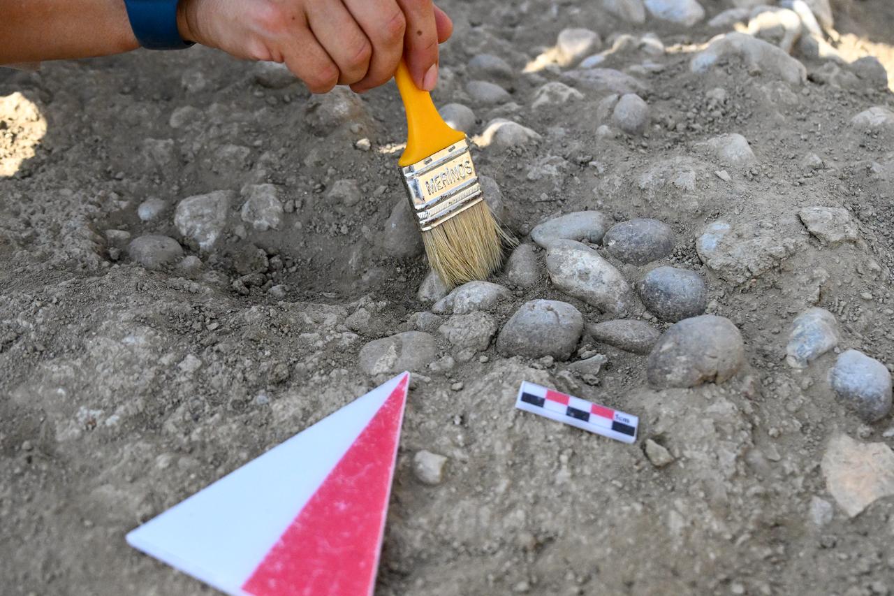Archaeologists work to unearth sling stones used in ancient wars during ongoing excavations at Cavustepe Castle, built by Urartian King Sarduri II, in Gurpinar district of Van, Türkiye, Aug. 28, 2025. (AA Photo)