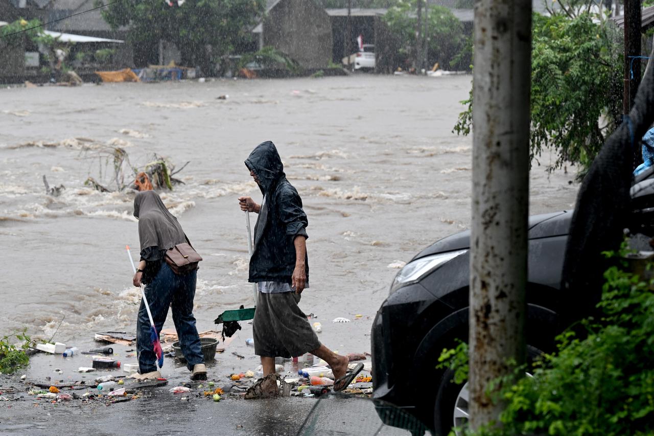 Residents affected by floods remove debris from their neighborhood after heavy rains hit Denpasar on Bali, Indonesia, September 10, 2025. (AFP Photo)