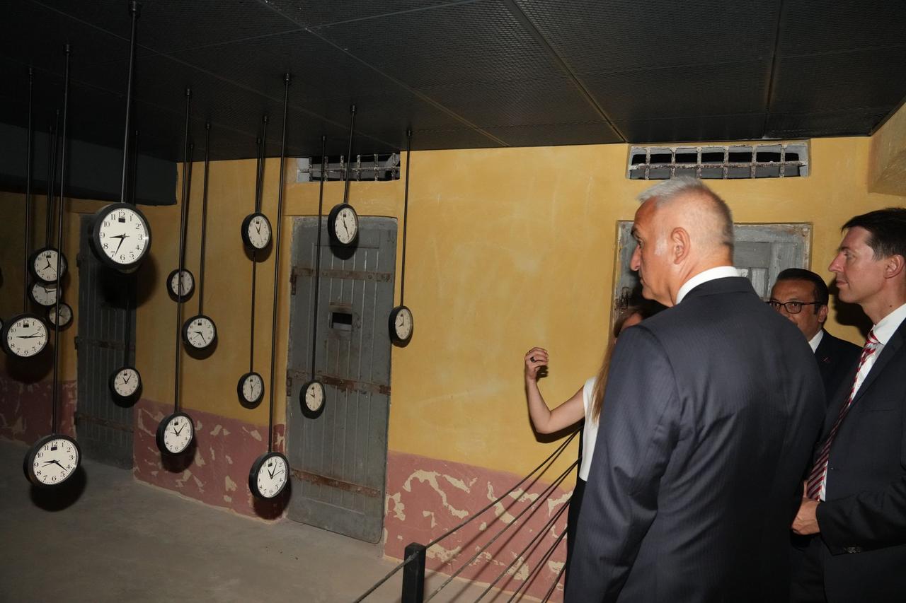 Minister of Culture and Tourism Mehmet Nuri Ersoy and visitors tour an installation featuring hanging clocks inside the Sinop Historical Prison Museum, reflecting on the passage of time once endured by inmates, Sept. 10, 2025. (Photo via Culture and Tourism Ministry)