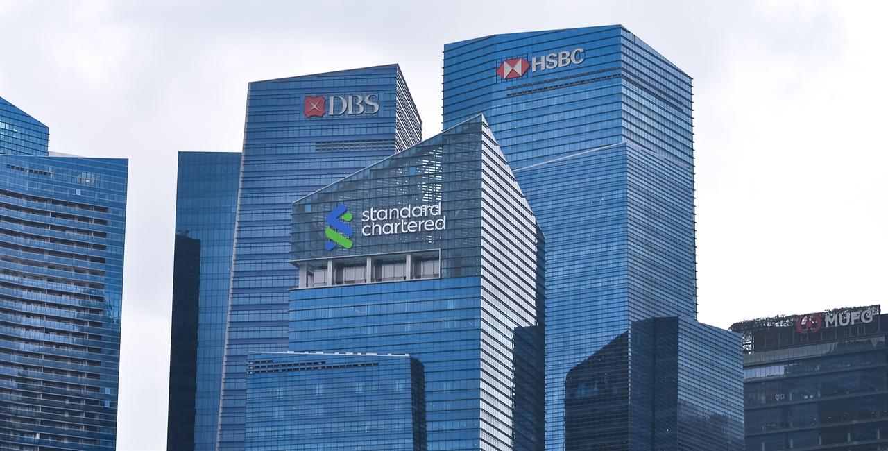 Skyscrapers of two big banks with their logos as seen from Gardens by the Bay in Singapore, January 20, 2024. (Adobe Stock Photo)