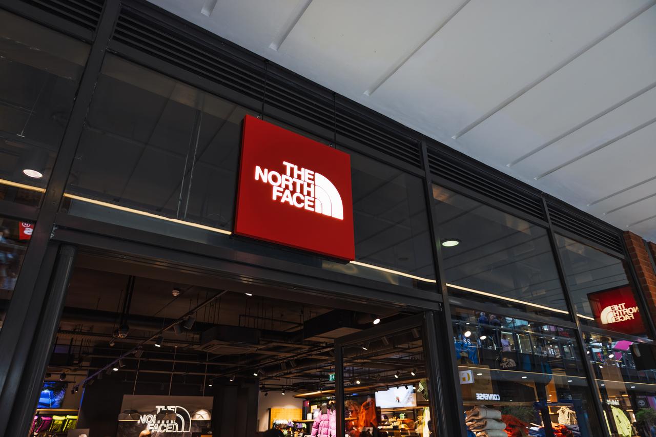 The North Face store exterior with bold illuminated logo and glass storefront in London, UK, 17 March 2024. (Adobe Stock Photo)