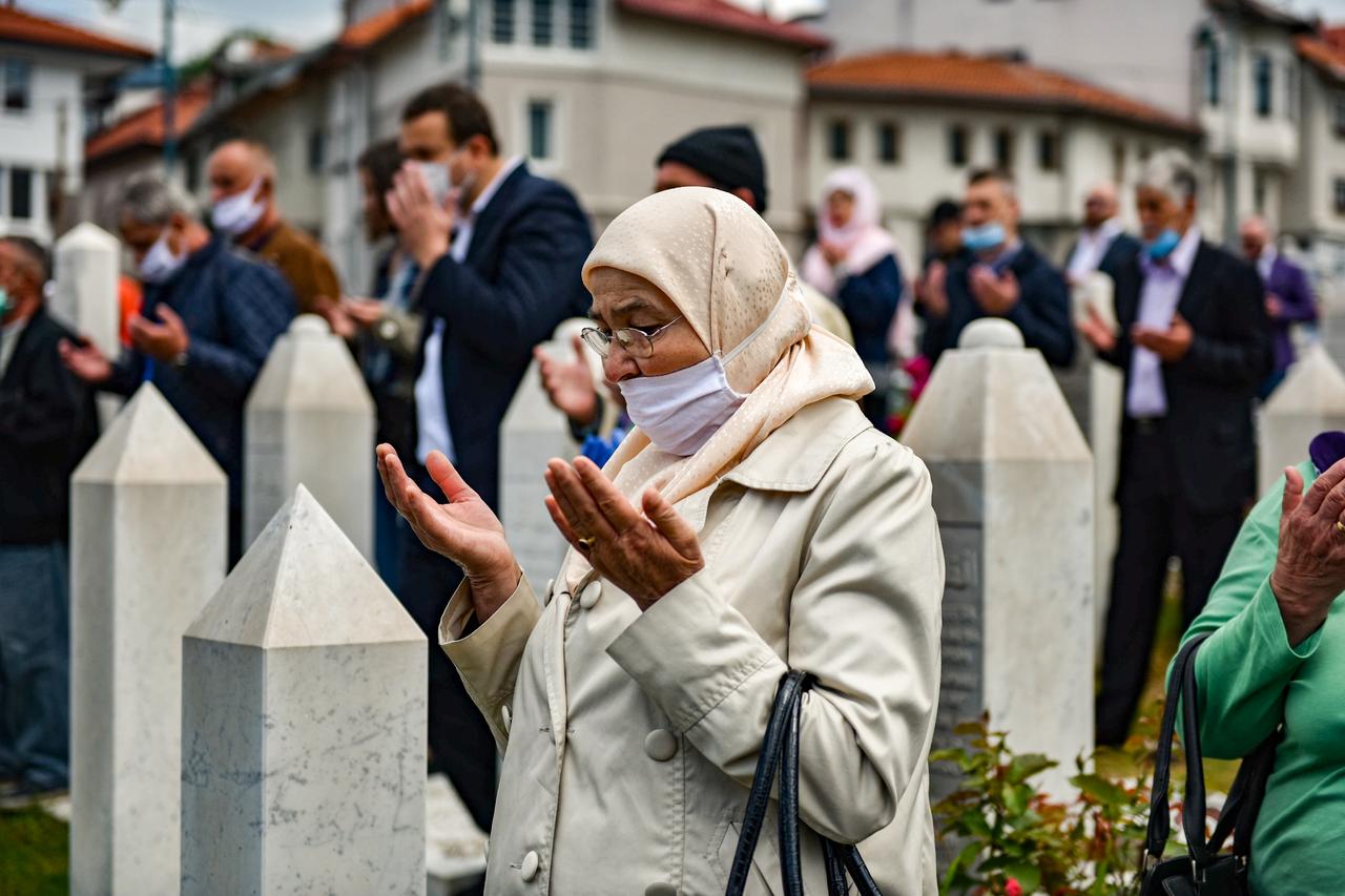 An elderly Muslim woman pays tribute to those who lost their lives in the 1995 war. Srebrenica Genocide Memorial, Bosnia and Herzegovina. (Adobe Stock Photo)