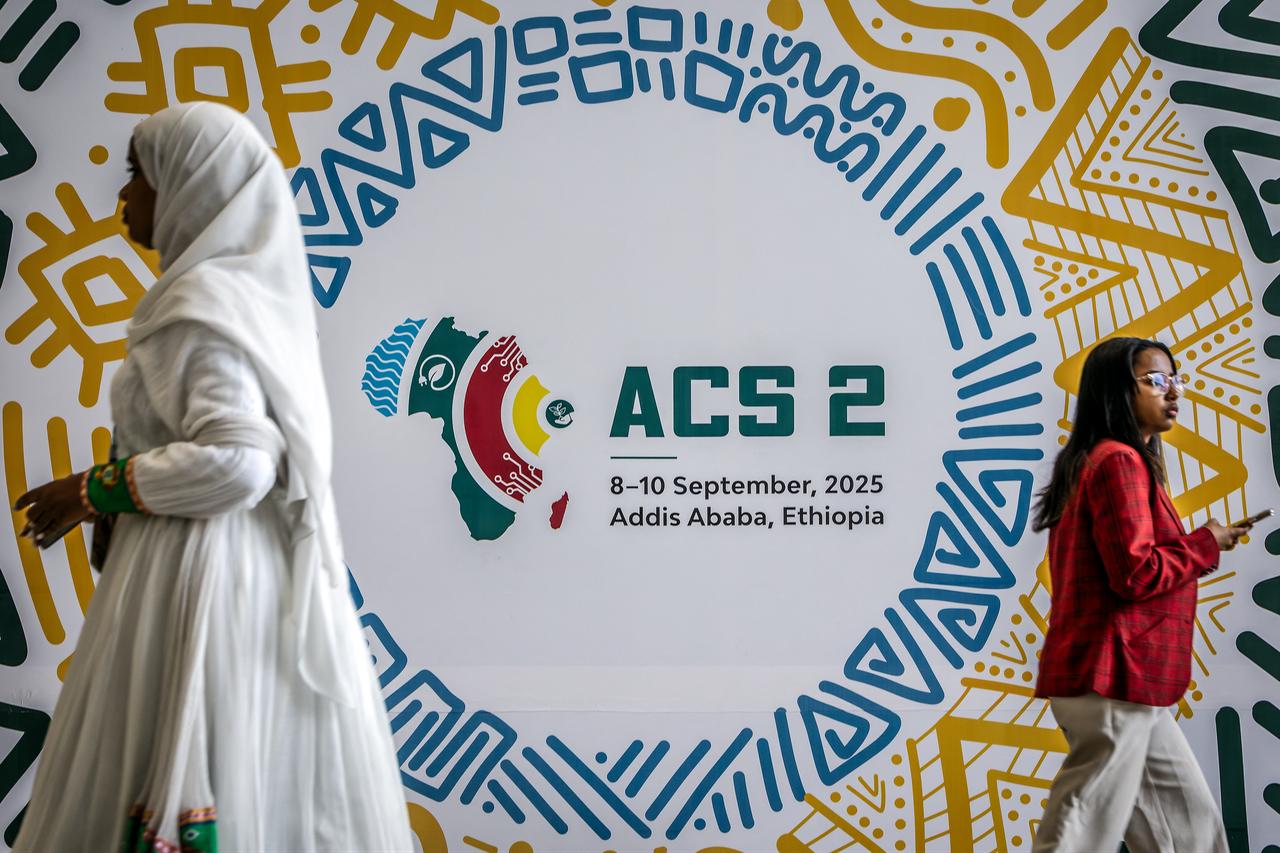 Delegates walk past a backdrop for the Second Africa Climate Summit (ACS2) during the opening of the High-Level Leaders Summit in Addis Ababa, Sept. 8, 2025. (AFP Photo)