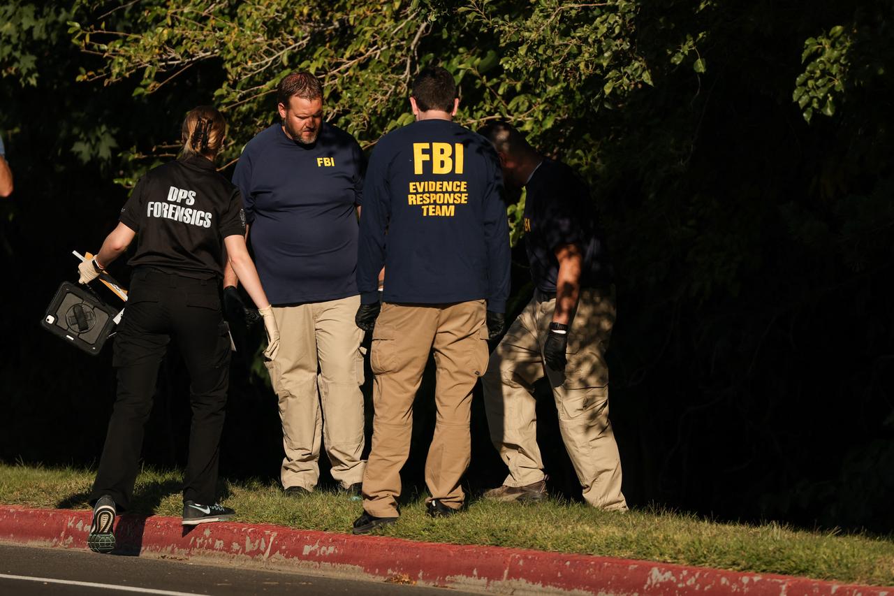 Law enforcement officials, including members of the FBI, investigate a wooded area near the crime scene where political activist Charlie Kirk was shot and killed at Utah Valley University in Orem, Utah, on Sep. 11, 2025. (AFP Photo)