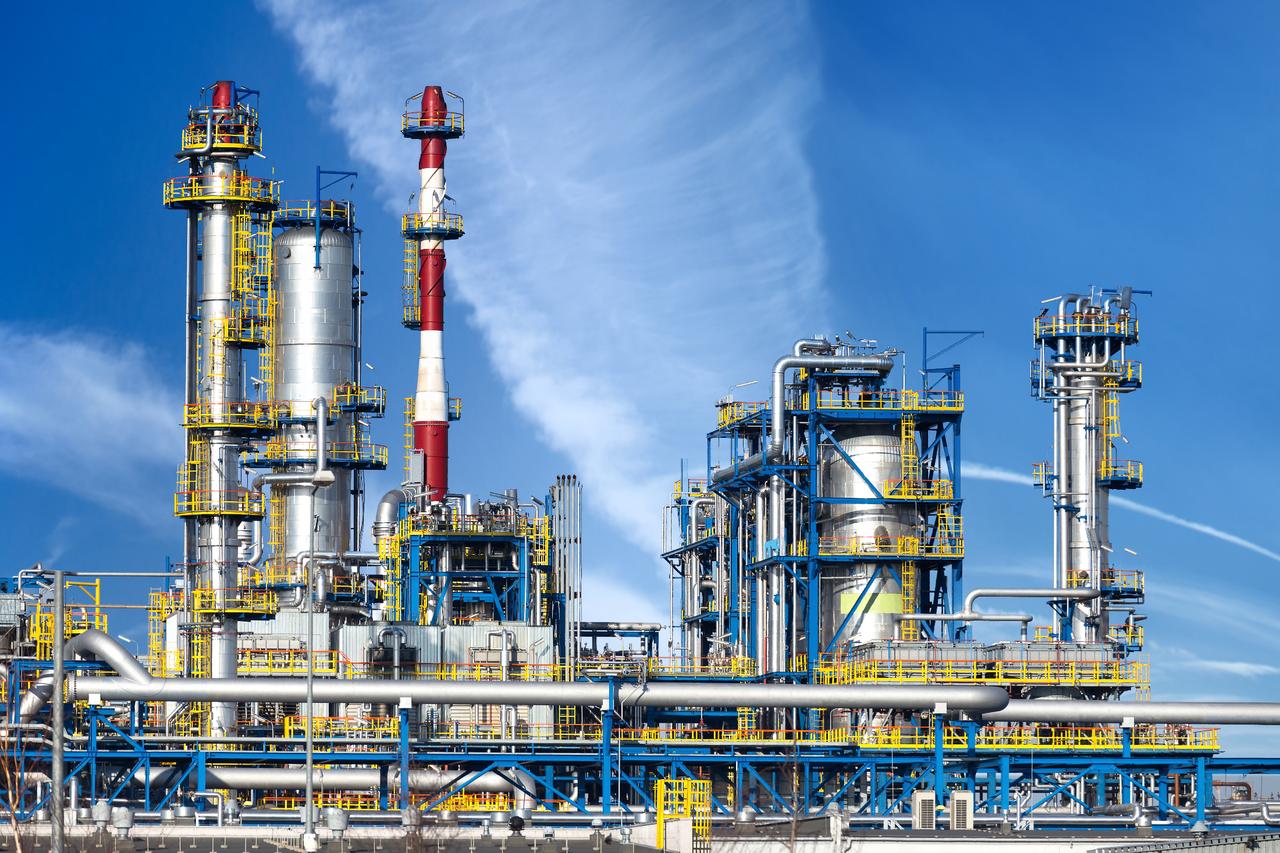 File photo shows an oil refinery complex with distillation towers and pipelines. (Adobe Stock Photo)