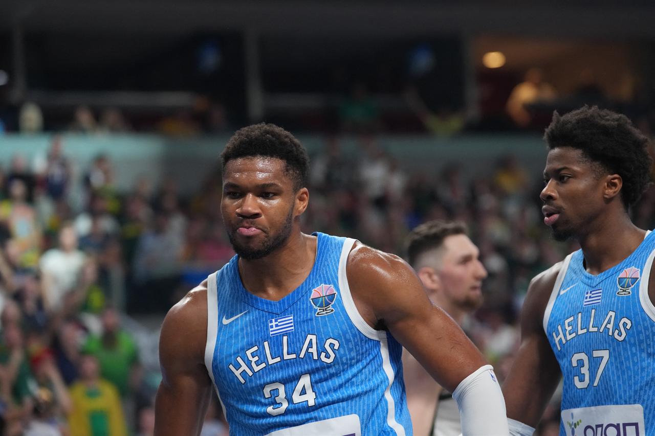 Greece's small forward #34 Giannis Antetokounmpo (L) and Greece's center #37 Kostas Antetokounmpo are seen during the FIBA EuroBasket 2025 basketball quarter final match between Lithuania and Greece at the Arena Riga in Riga, Latvia, September 9, 2025. (Photo by Gints Ivuskans / AFP)