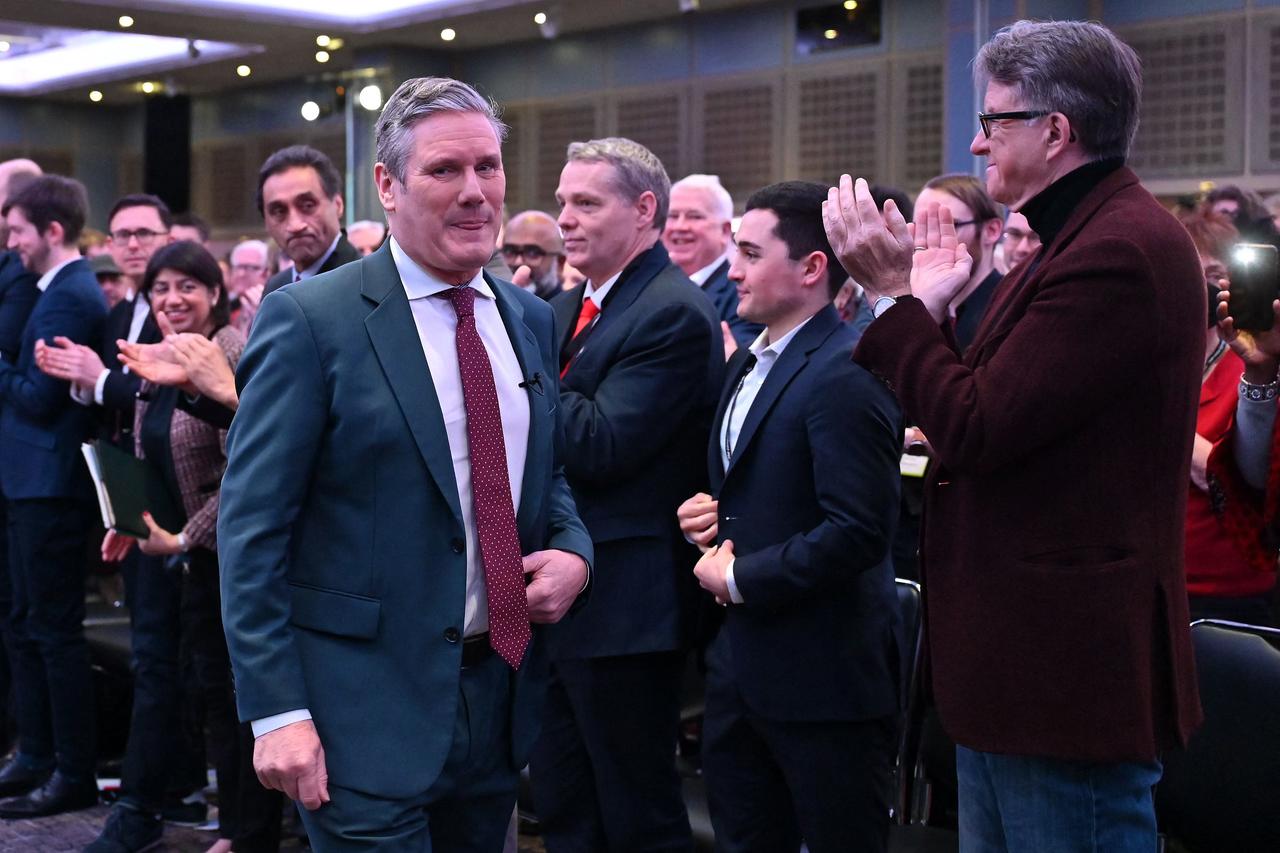 Britain's main opposition Labour Party leader Keir Starmer (L) acknowledges applause from delegates, including Peter Mandelson (R), as he leaves the stage after addressing them during the London Labour Regional Conference in central London on January 28, 2023. (AFP File Photo)