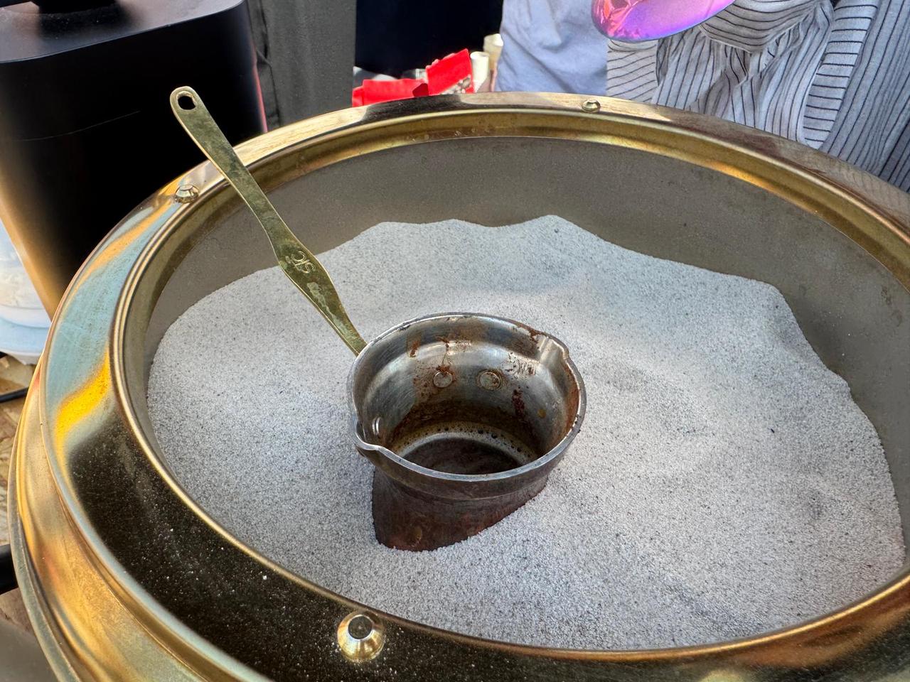 Traditional Turkish coffee is brewed in hot sand at the Istanbul Coffee Festival in Kadikoy, Istanbul, Türkiye, Sept. 11, 2025. (AA Photo)