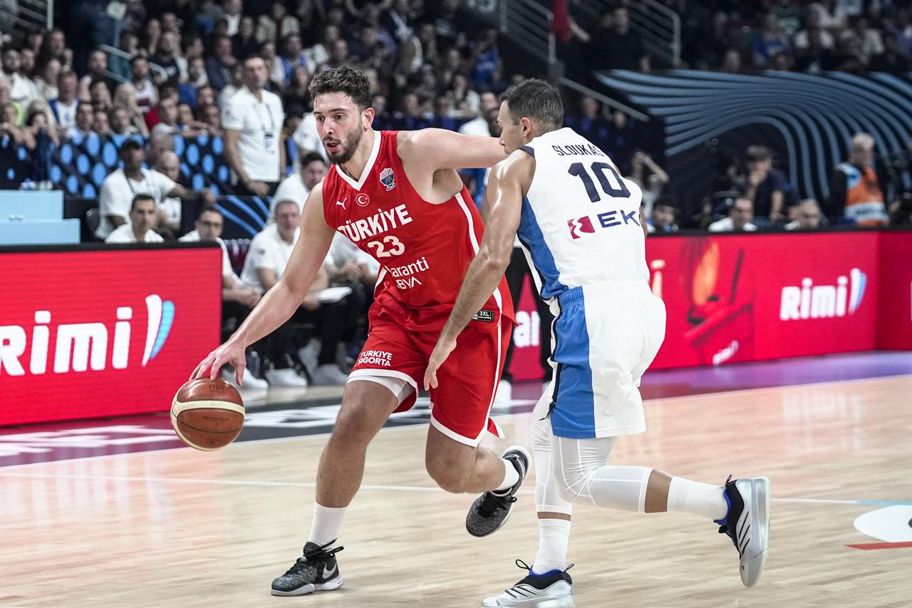 Alperen Sengun (23) of Türkiye in action against Kostas Sloukas (10) of Greece during the FIBA EuroBasket 2025 semifinal match between Türkiye and Greece at Riga Arena in Riga, Latvia, September 12, 2025. (AA Photo)