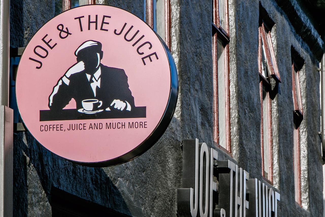 A Joe & The Juice sign hangs above the entrance of a branch in Reykjavik, Iceland, August 22, 2017. (Adobe Stock Photo)