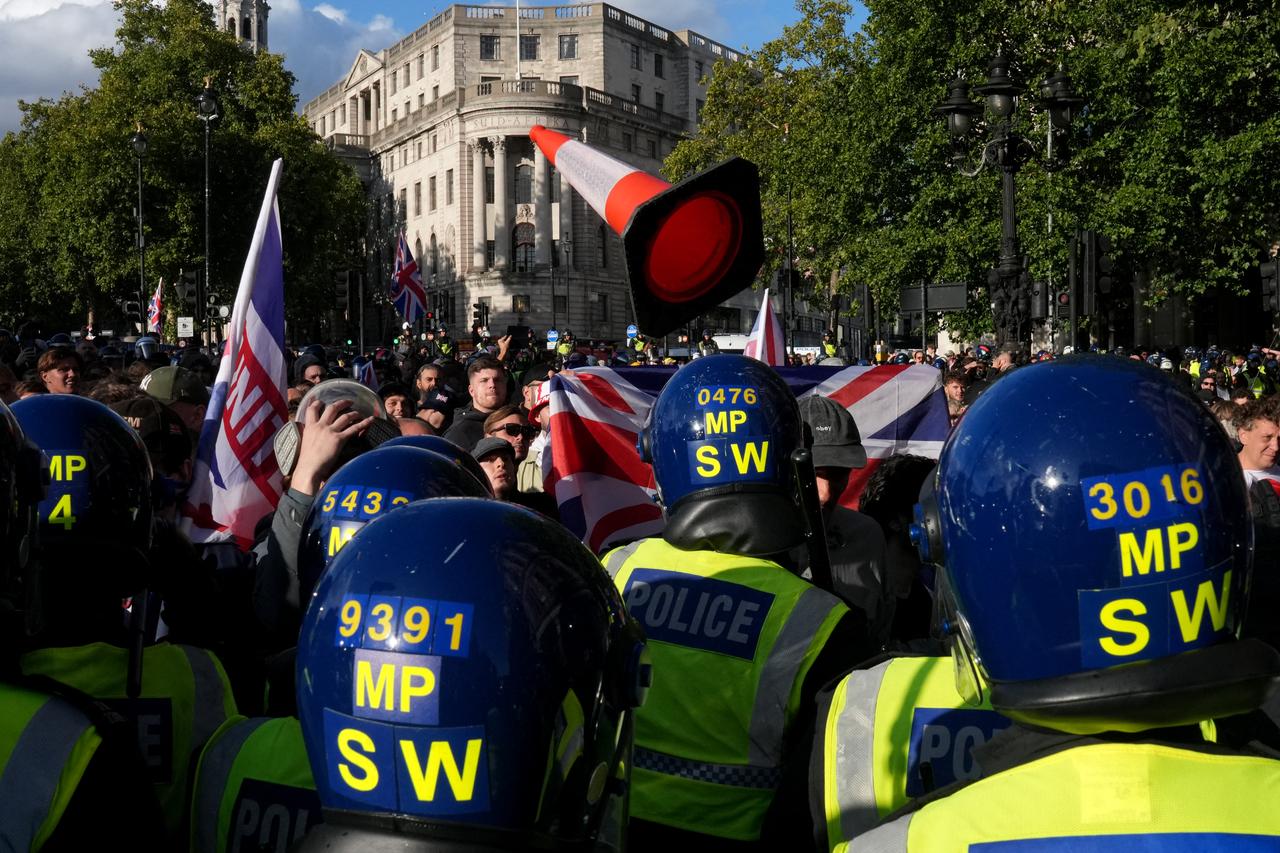 A traffic cone is thrown towards police officers as supporters of British far-right activist Tommy Robinson whose real name is Stephen Yaxley-Lennon, gather during a Free speech march, in central London on Sep. 13, 2025. (AFP Photo)