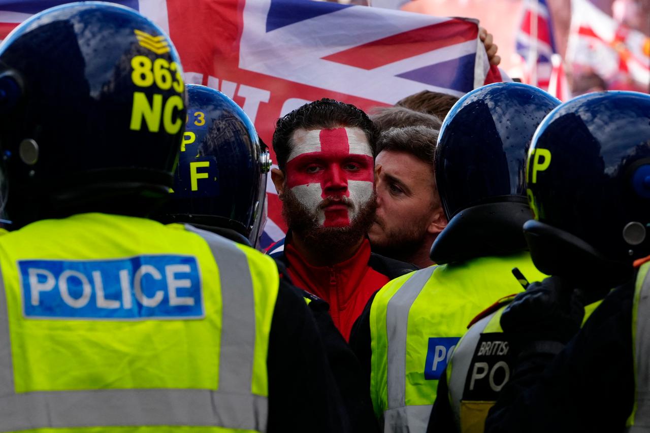 A person wears St George's Cross face paint as supporters of British far-right activist Tommy Robinson whose real name is Stephen Yaxley-Lennon, gather during a 'Free speech' march, in central London on Sep. 13, 2025. (AFP Photo)