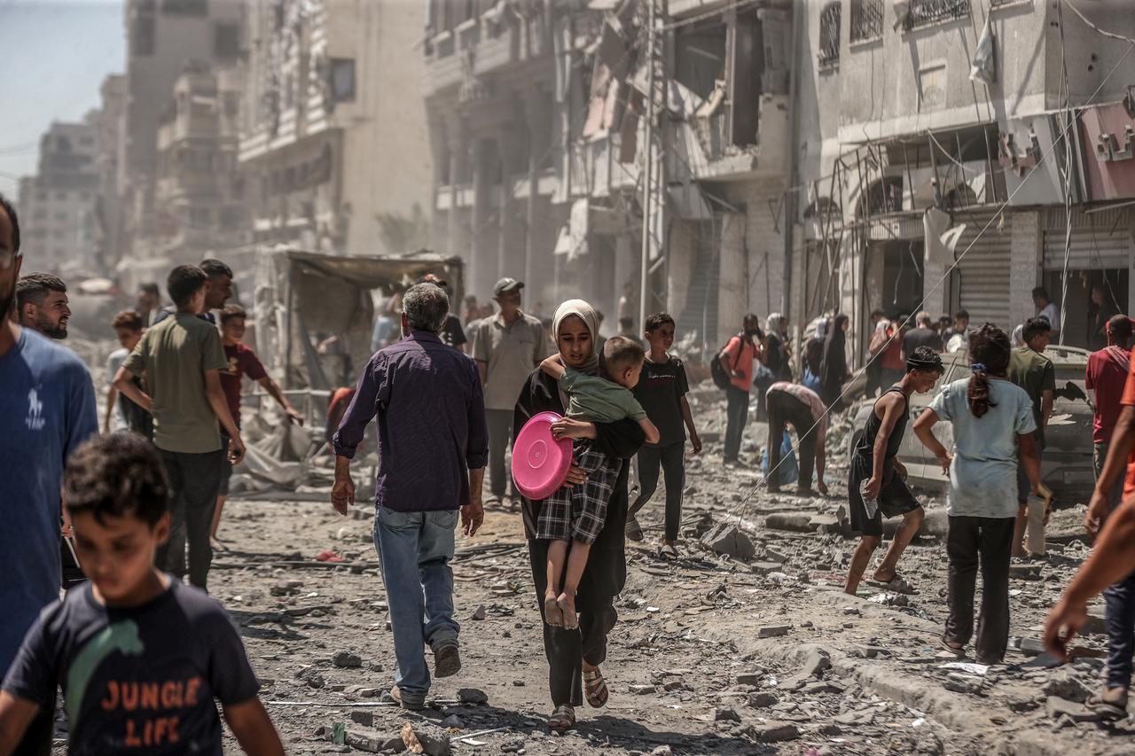 Palestinians left the area after the Israeli army carried out an attack on the Nasr neighborhood, where several buildings were destroyed and rendered completely unusable in Gaza City, Gaza, on September 12, 2025. (AA Photo)