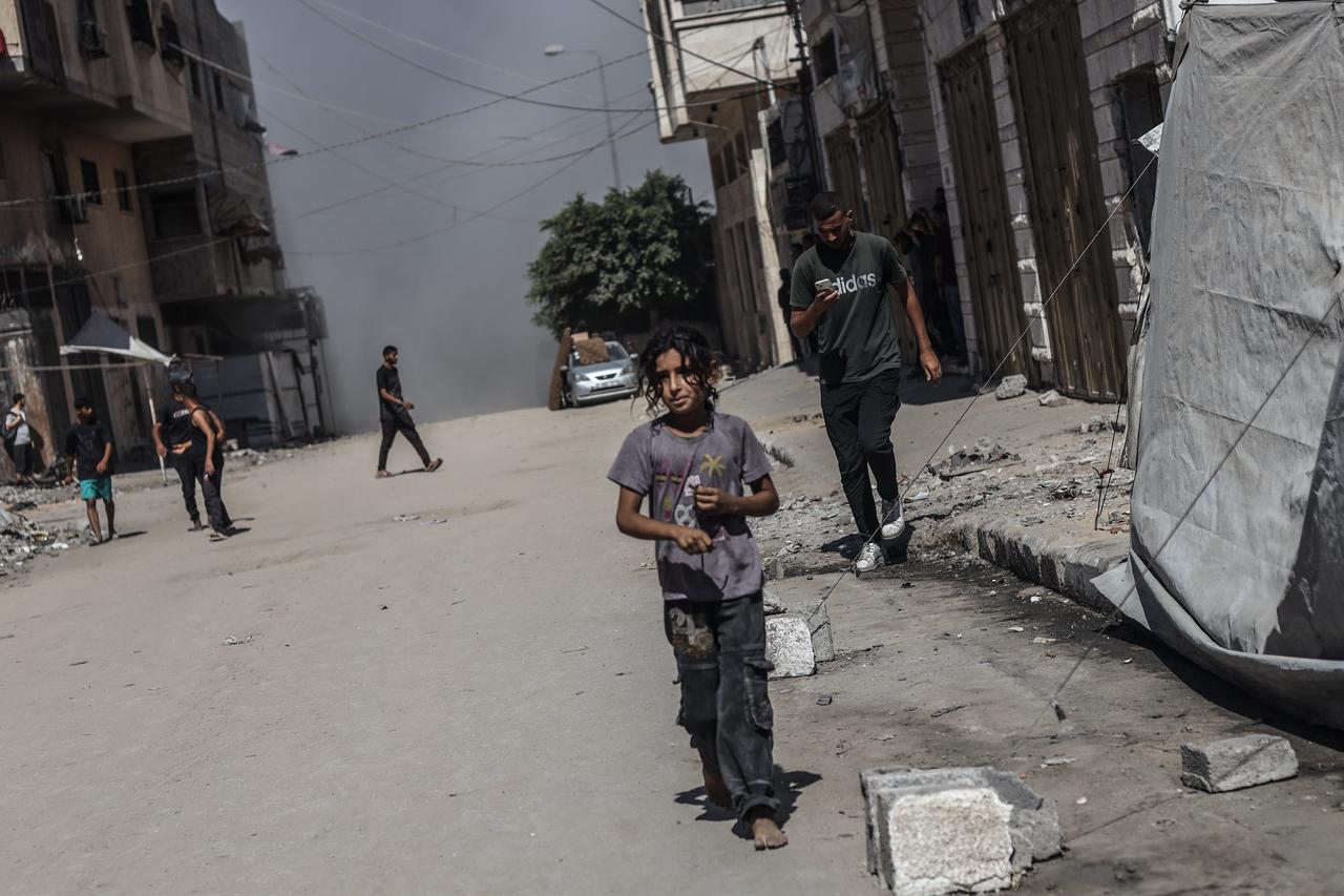 Palestinians left the area after the Israeli army carried out an attack on the Nasr neighborhood, where several buildings were destroyed and rendered completely unusable in Gaza City, Gaza, on September 12, 2025. (AA Photo)