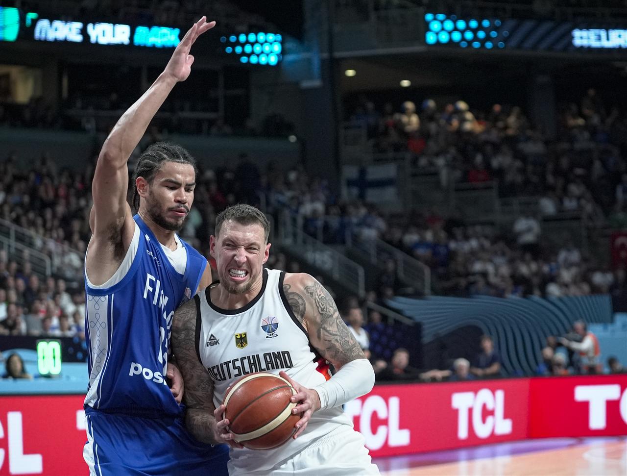 Daniel Theis (R) of Germany in action against Olivier Nkamhoua (13) of Finland during the FIBA EuroBasket 2025 semifinal match between Germany and Finland at Riga Arena in Riga, Latvia, Sept. 12, 2025. (AA Photo)