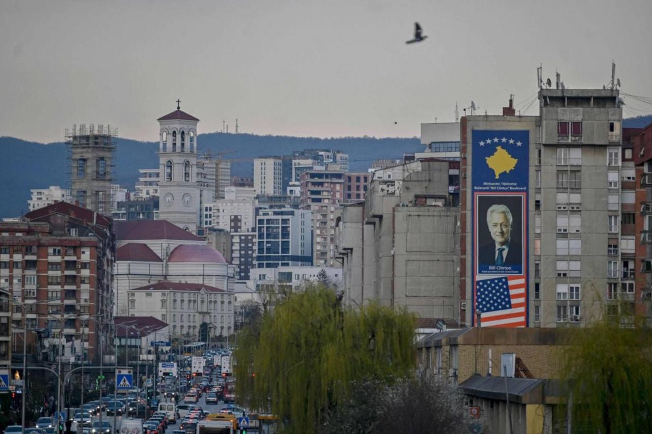 This photo shows a big banner depicting a portrait of former U.S. President Bill Clinton along with United States and Kosovo flags in Pristina, Kosovo, on March 22, 2024. (AFP Photo)